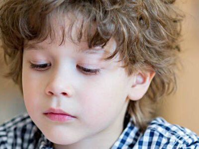 boy writing in classroom