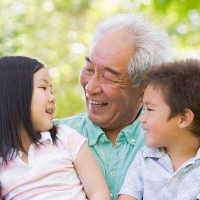 Grandfather laughing with grandchildren